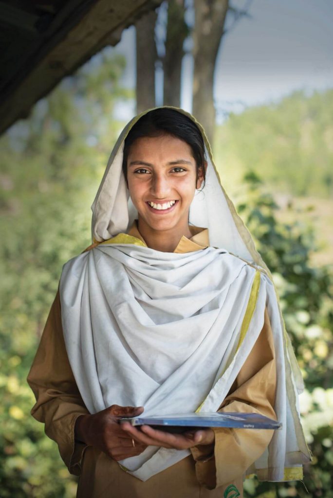 Having spent a long morning completing chores, Rabia is now headed to school